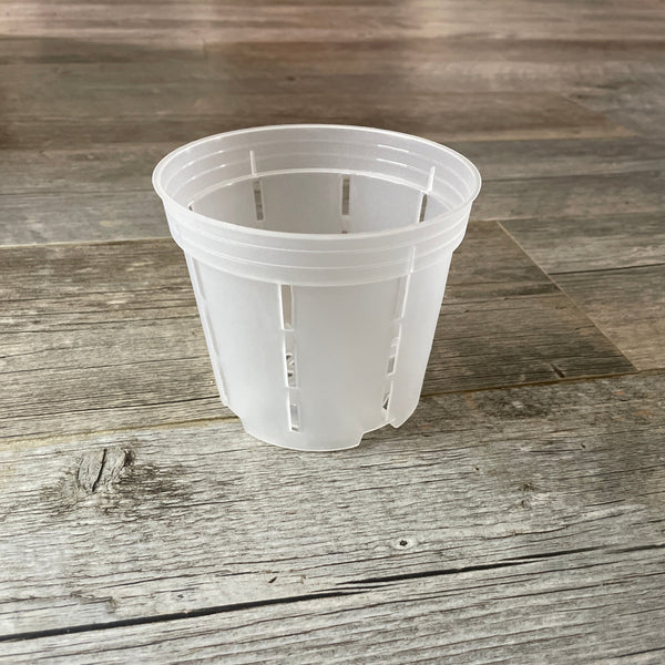 a 5" transparent round plastic orchid pot with side slots
