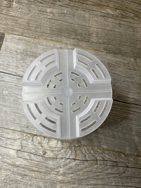 a view of the bottom of a 6" transparent orchid pot with side slots, showing the drainage holes on the bottom of the pot