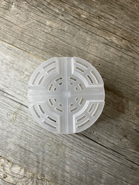 looking at the mesh bottom of a 5" round transparent orchid pot showing the many drainage holes