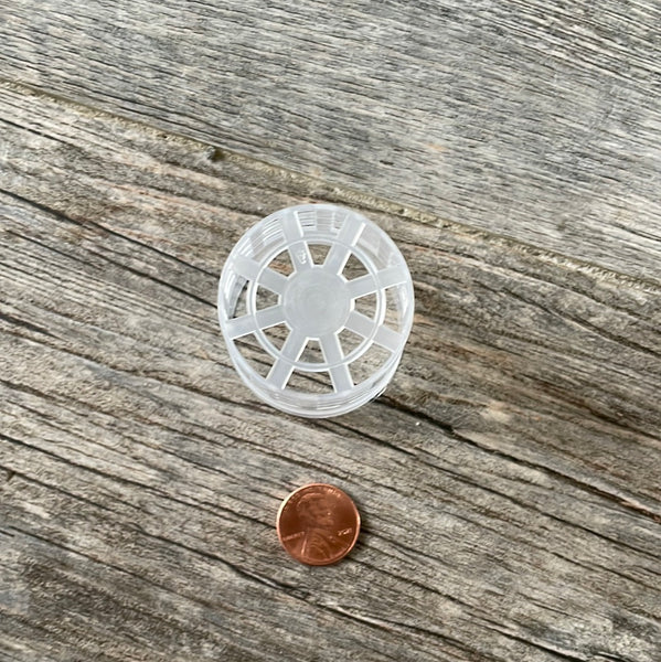 the bottom of a tiny 1.5" clear mesh pot with a penny for size comparison