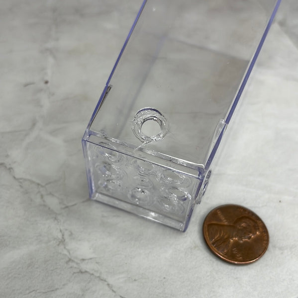 showing the holes on the side and bottom of a 1.5" clear square orchid and succulent pot