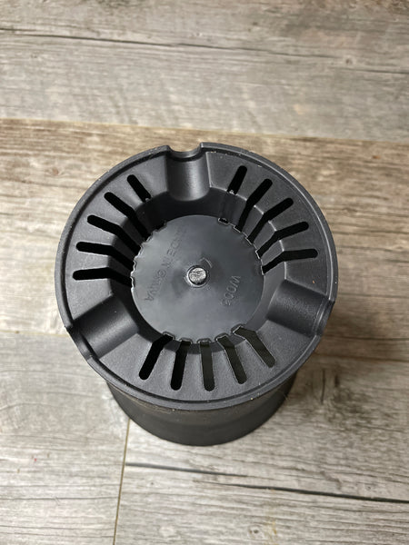 the bottom of a 6.25" round black succulent pot showing the drainage holes