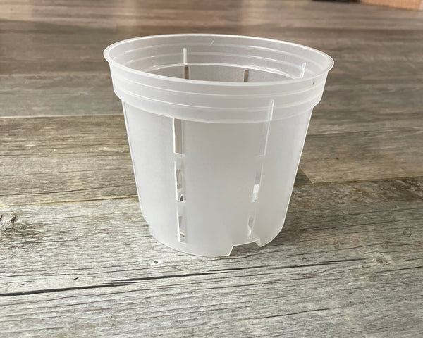 a side view of a 6" transparent orchid showing the slots on the side and the raise bottom feet