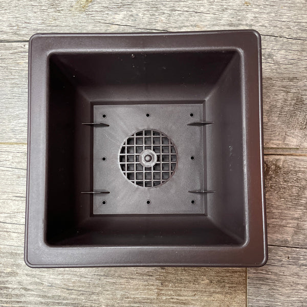 view from above of a brown square 6.6" bonsai pot showing the mesh drainage holes in the bottom