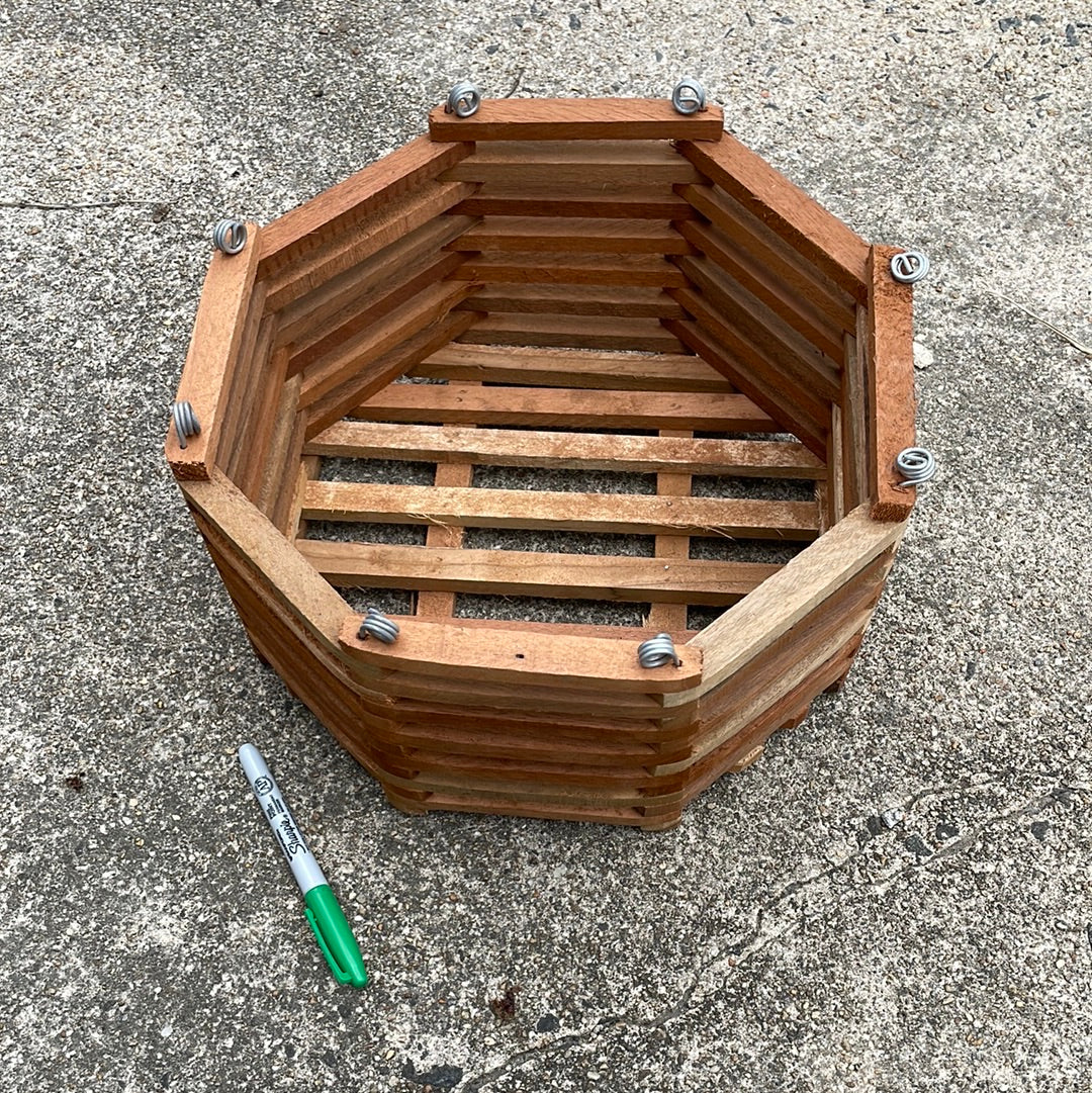 a 12" octagonal slatted wooden vanda  basket with eight metal rings for hanging it