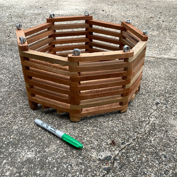 side ways view of a 12" octagonal wooden slatted vanda basket